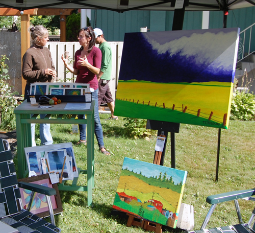 Painter Tina Lindegaard (left) talks with Miriam Manley at Kristina Metzlaff's home on Railway Avenue — the second stop on the 2015 Garden and Art Tour. David F. Rooney photo