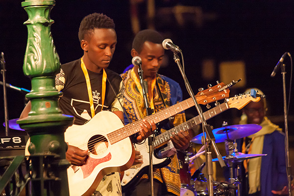 Two members of the Nyundo School Road Show tune up their guitars. Jason Portras photo