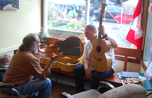 Bob Gardali (left) talks about one of his favourite subjects, acoustic strong instruments, with Jowi Taylor of Six String Nation after his presentation at the Modern Cafe n Saturday. David F. Rooney