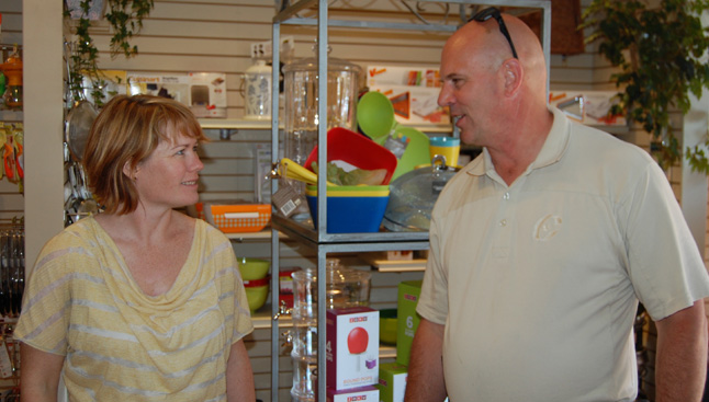 Nicole Cherlet was having a banner day with sales during the Heritage Weekend Sidewalk Sale when Conservative candidate David Wilks dropped in for a quick visit. David F. Rooney photo