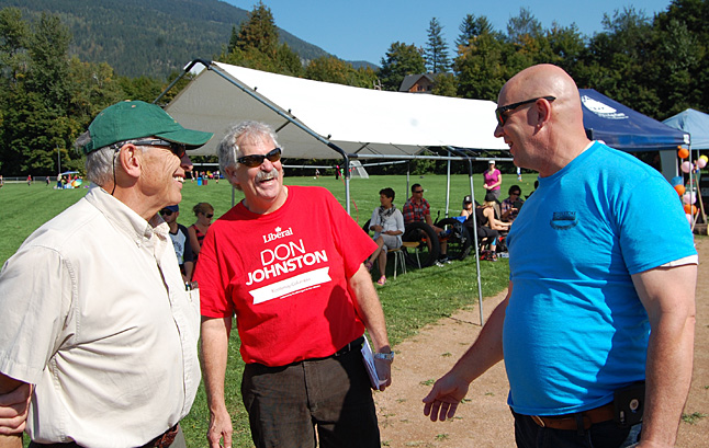 Geoff Battersby shares a chuckle with political opponent Don Johnston of the Liberal Party and David Wilks of the Conservatives. Johnston and Wilks both happened to be campaigning in Revelstoke on the weekend and met for the first time at Timber Days. David F. Rooney photo