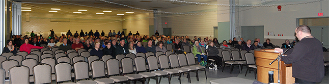 A crowd of more than 238 curious people attended Tuesday night’s open house about the zoning changes for the proposed highway strip mall. City Development Services Manager Dean Strachan made a 14-minute presentation about the history of the proposed zoning changes sought by developer Hall Pacific and how the process will now proceed. People started filtering in to the Community Centre at 6:30 pm, shortly before this photo was taken. Please click here to see a larger version of this image. David F. Rooney photo