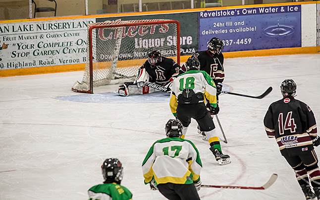 Grizzlies Goalie #30 Domenic Donato stretches out, but can’t quite reach the puck slung by Oilers #7 Liam Bartlett midway through the First Period. Jason Portras photo