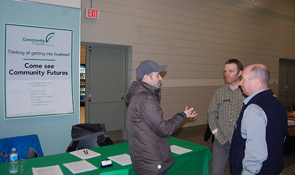 Kevin Dorrius (right), manager of the Community Futures Corporation, listens as he talks with two of the attendees at the Volunteer fair. CFDC offers support to businesses of all kinds in Revelstoke. David F. Rooney photo