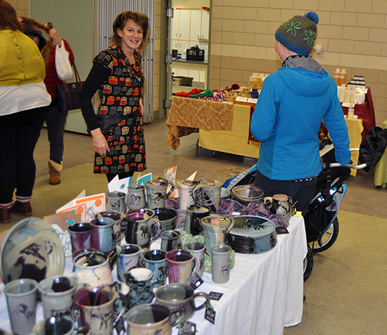 Potter Jacqueline Palmer chats with a potential customer at the market. Jacqueline produces very distinctive and lovely pottery pieces ranging from cups, mugs, bowls and plates to larger pieces such as fondue sets. David F. Rooney photo