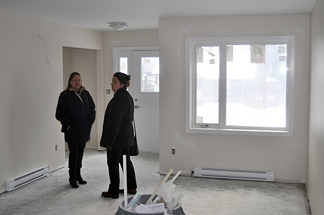 Housing Society Directors Loni Parker (left) and Cathy Girling chat in the living room of one of th projects singe unit. David F. Rooney photo