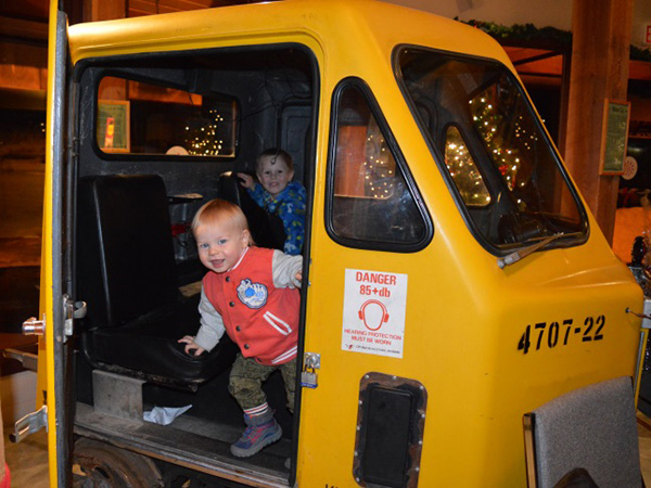 Three-year-old Oliver Fitzmaurice and 14-month-old Holden Hill play in the motor car, ‘speeder’ or railcar, that rides the rails. Laura Stovel photo