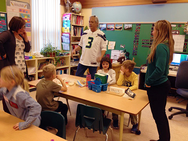 Children at Columbia Park Elementary School experienced the old-fashioned joys of exchanging hand-written letters with pen pals of their own age on Friday, January 8. Virgil Seymour (center), the Sinixt’s Arrow Lakes representative, looks on with Columbia Park Elementary Principal Ariel MacDowell (left) and teacher Stephanie Noel (right) as students read letters sent to them by kids at Inchelium Elementary School on the Colville Reservation in Washington. Laura Stovel photo