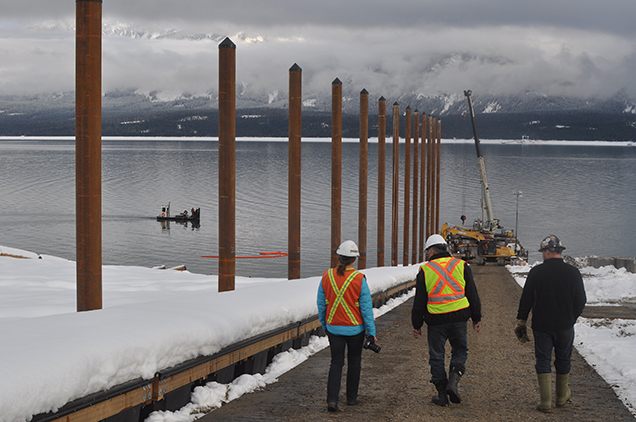 BC Hydro's Community Laision, Peter Bernacki and Foreman Bill Illidge walk past the pylons that will support the floating wooden walkway. David F. Rooney photo