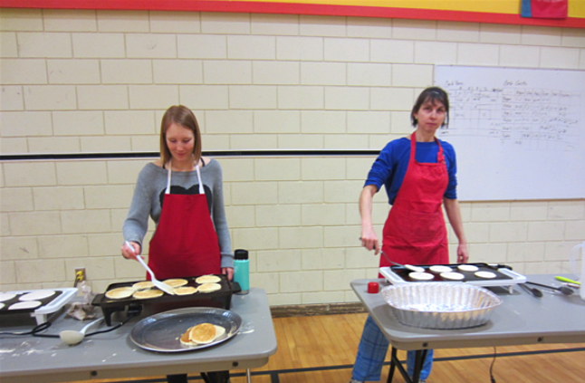 Student teacher Georgia Mackenzie (left) and Grade 5/6 teacher Michelle Gadbois cooking up some delicious pancakes. Todd Hicks photo. Caption by Emily Macleod, Amelie Delesalle and Rebecca Grabinsky