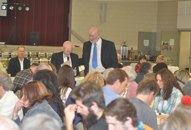 Master of Ceremonies George Buhler invites Jack Carten to sat grace at the beginning of the dinner. David F. Rooney photo