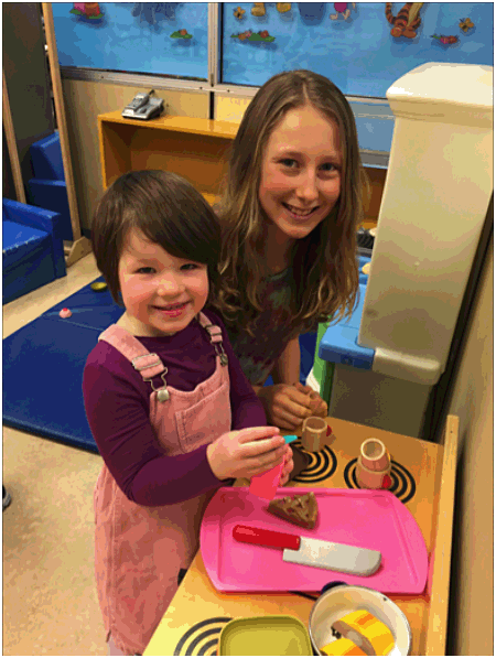 Edith Garratt and Emily MacLeod making a snack together.  Photo by Monica Degerness. Caption by Emily MacLeod, Amelie Delesalle and Rebecca Grabinsky 