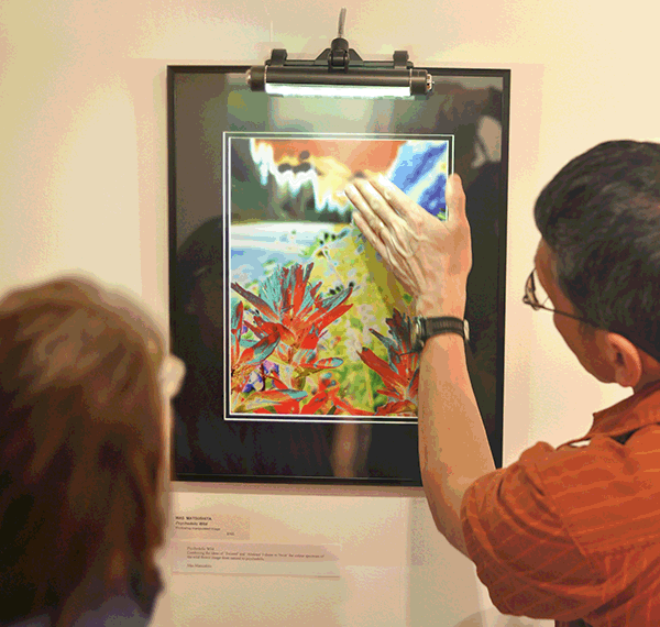 Mas Matsushita (right) discusses his work, Psychedelic Wild, with fellow artist Coreen Tucker. David F. Rooney photo