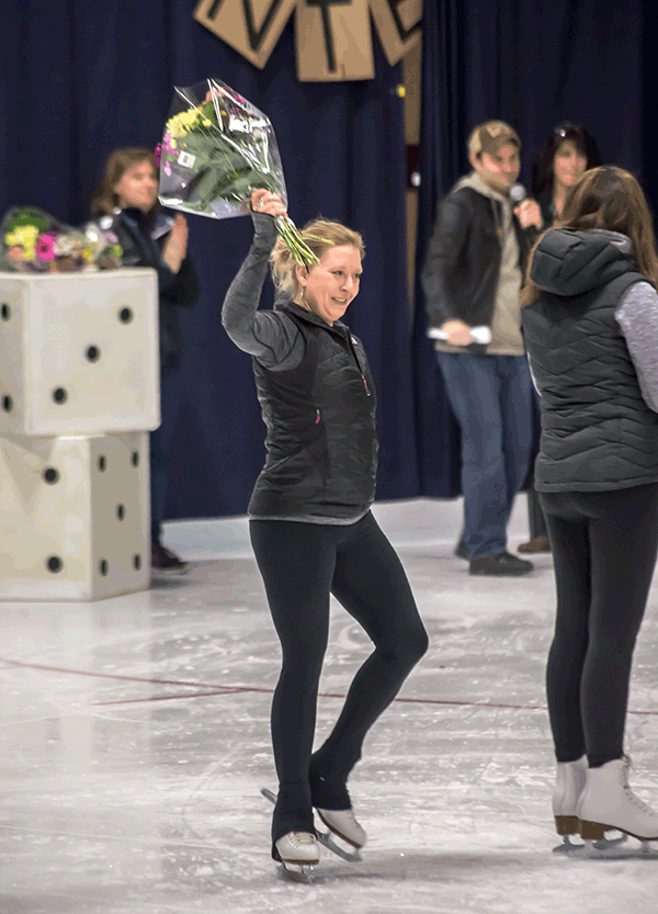 Coach Adrienne Schurdevin receives flowers as thanks for all her hard work. Jason Portras photo