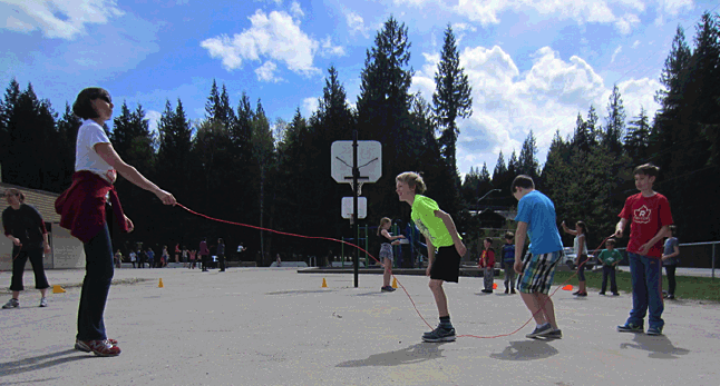 This is classroom teacher Michelle Gadbois with students Reed Kelly, Mitchel Legebokow, and Parker Aucoin jumping with the long ropes. Todd Hicks photo. Caption by Emily MacLeod and Amelie Delesalle 