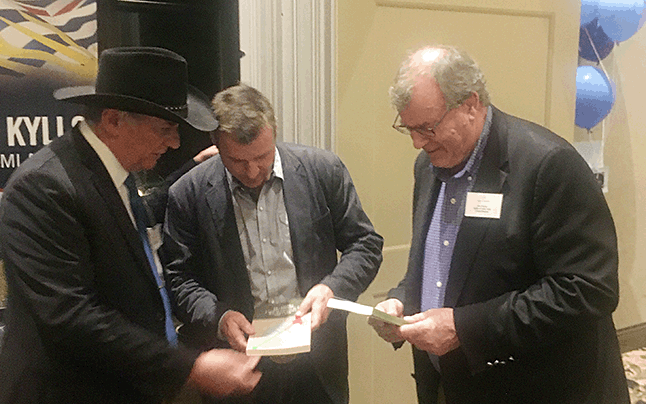 BC Forestry Minister Steve Thomson (right) and fellow BC Liberal MLA Greg Kyllo (center) were pleased to receive copies of George Benwell’s autobiography, 25/100ths A Quarter Century in the BC Forest Service 1955-1980, from Revelstokian Peter Bernacki (left) during a party meeting in Salmon Arm last Friday, April 15. Peter regularly meets ministers of the Crown and other BC Liberal MLAs to promote Revelstoke’s local interests. Not that he doesn’t value the work of our riding’s New Democratic MLA Norm Macdonald — he does; he just thinks you can’t do enough to ensure the provincial government pays attention to rural ridings like ours. Cell phone photo courtesy of Peter Bernacki
