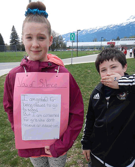 Grade 6 student Parker English and Grade 7 student Caden Hedley stay silent for the right to an education for all the children in the world. Eleanor Wilson photo