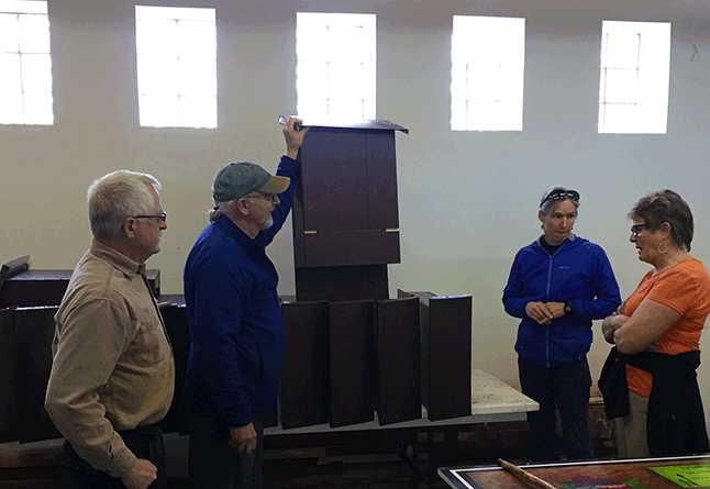 Ken Talbot and Marc Paradis (left) show off the 12 bat boxes they built for the Illecilleweat Greenbelt Society, represented here by its chairwoman, Louisa Fleming (right), and bat biologist Mandy Kellner (right center). These sleek-looking bat houses will be installed in the Greenbelt along the Illecillewaet River this spring. Members of the public or members of other non-profit groups who would like to help the Greenbelt Society erect the bat houses should click here to send Louisa an e-mail indicating their interest. David F. Rooney photo