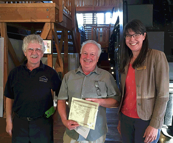 Railway Society President Dean Handley (left) and executive director Jennifer Dunkerson pose with long-time volunteer Darryl Willoughby after presenting him with a certificate in honour of his more than 20 years of service. Dedicated volunteers like Willoughby keep organizations like the Railway Museum humming along. David F. Rooney photo 