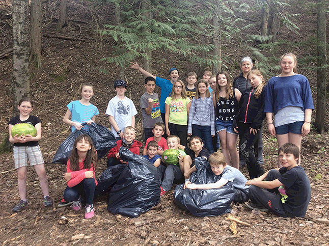 Students taking art in Beyond Recycling, a 24-week Wildsight program that tackles topics such as energy, waste and consumption. worked hard to clean up a natural area often used by the school as an outdoor classroom. They filled up four large garbage bags and were surprised by what people had tossed out. Photo courtesy of Wildsight