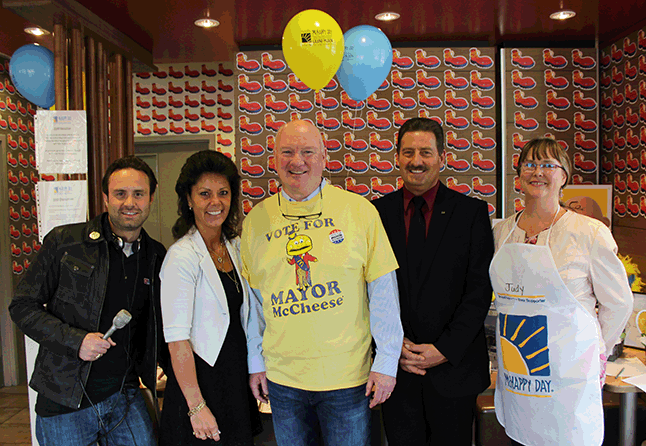 Mayor Mark McKee sported a new shirt for the day as he posed with EZ Rock's Shaun Aquiline (left), restaurant owners Cathy and Kevin Blakely, and outgoing Chamber of Commerce Executive Director Judy Goodman. Photo courtesy of Cathy and Kevin Blakely