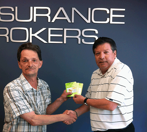 Randy Gribble (left) was very pleased to be picked as the winner of $300 in Coopers Gift Cards offered through a HUB International Insurance Brokers promotion. Randy picked up his winnings on Tuesday, May 3, from Branch Manager John Grass at the agency’s new office at 301B Victoria Road. Photo courtesy of HUB International Insurance Brokers 