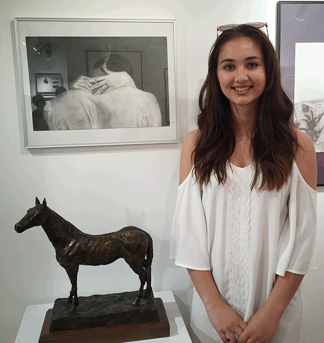 Gabrielle poses with a small bronze horse she created. Her Uncle Peter helped her with the bronze. David F. Rooney photo