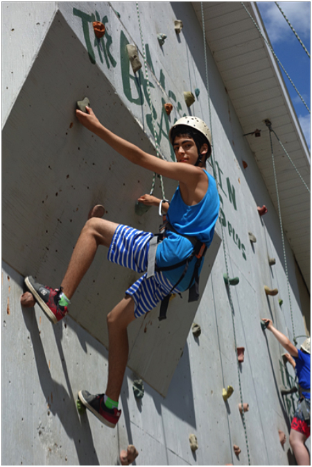 This is Landon Camara climbing The Beast on the rock wall. Here are Cassidy Legebokow and Michael Mierstch doing the tire course at low ropes. Ron Larsen photo. Caption by Emily MacLeod, Amelie Delesalle, and Rebecca Grabinsky