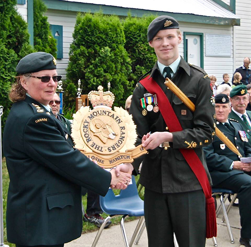 CWO Alex Tilden presents the Reviewing Officer with a gift from the Revelstoke Cadets. Photo courtesy of Capt. Miken Rienks