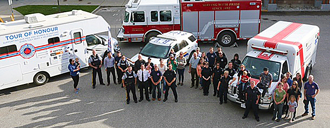 Local RCMP officers, fire fighters and paramedics turned out to greet the Honour House Tour of Honour when it arrived in town late Thursday afternoon. They met the Honour House Tour RV by the Columbia River Bridge and escorted it into town and through the downtown core, attracting a lot of attention along the way. Photo courtesy of the Revelstoke Fire Rescue Service