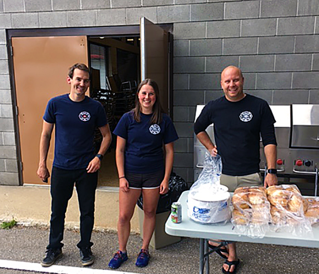 James Bacon, Megan Cottingham and James MacDonald helped serve up some pretty tasty bacon cheeseburgers at the BBQ. Photo courtesy of the Revelstoke Fire Rescue Service