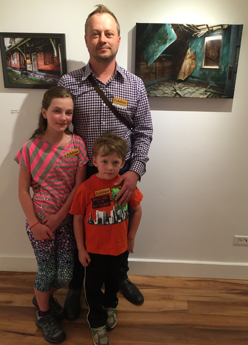 Photographer Jason Keerak poses with his children Ava and Ivo at the opening of his show, Abandoned. This is an excellent and intriguing selection of images taken of abandoned houses in Saskatchewan. While most of the photos are his, Ava and Ivo have their own entries which just goes to show that the apple doesn't fall far from the tree. David F. Rooney photo