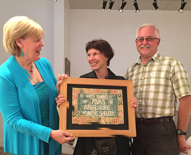 The Revelstoke Women's Shelter's Laura Stovel presented Jackie Pendergast and Ken Talbot with a hand-crafted tile thank you created by potter Sandra Flood. She said the Shelter deeply appreciates the way that the Visual Arts Society has assisted shelter residents and their children. David F. Rooney photo