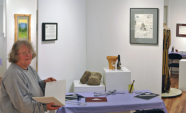 Jo Willems poses by the display of classroom drawing books and objects her students used in some of their in-class still-life sessions. You can browse through the notebooks and, should you so desire, even crete your drawings in the sketchbooks. Her class' show, Roots, Stumped, Growth: Fierce Art Project, which opens on Friday, July 8. David F. Rooney photo