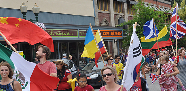 The flags carried by Multicultural Society members represent nationalities that are represented in our city. David F. Rooney photo