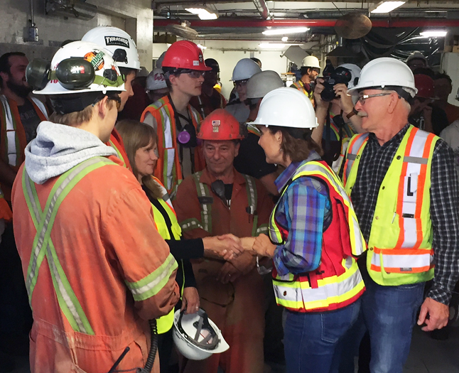 Clark shakes hands with one of the mill's female workers. David F. Rooney photo