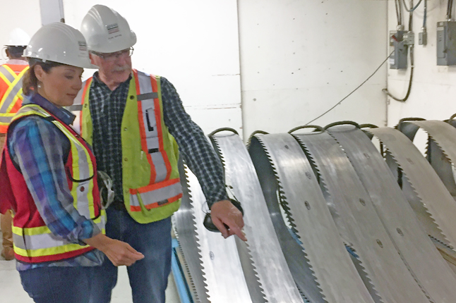 The premier admires a set of very sharp saw blades as Alan explains their uses. David F. Rooney photo