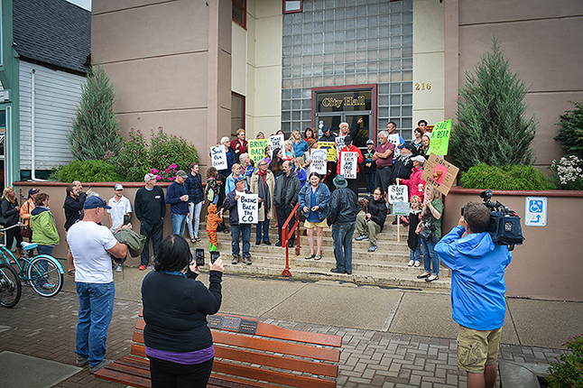 Protestors in front for the TV camera on the steps of City Hall on Monday. John Morrison photo 