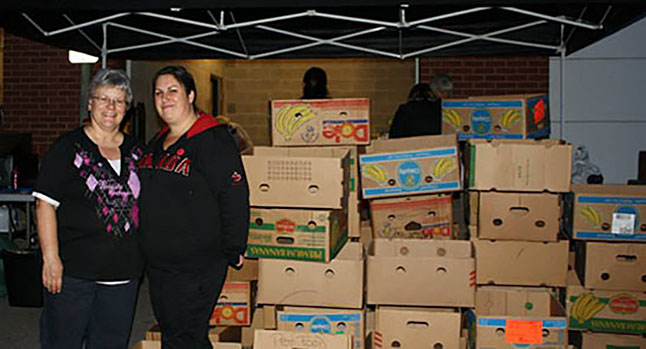 This year’s Emergency Services Food Drive will mark the end of Krista Kallio’s (that's Krista on the left) involvement with the Revelstoke community’s food-drive campaigns. In early September, she will be "moving on from Revelstoke.” Krista and Patti Larson (on the far left) pose with soon-to-be-filled boxes at the start of an Emergency Services Food Drive. Revelstoke Current file phoro