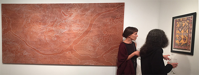 Laura Stovel and Katheen discuss one of the pieces in the show. Please click on the image to see this photo in a larger format. David F. Rooney photo