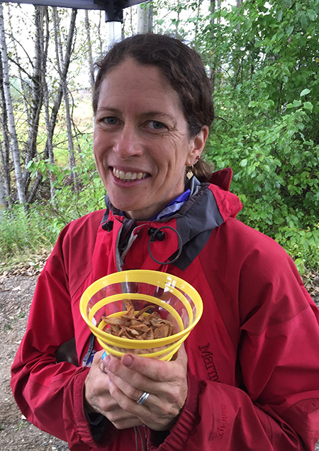 Sarah Newton offers up a container of tasty roasted burdock chips. They were surprisingly good. David F. Rooney photo