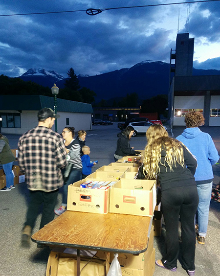 As the light fades, volunteers were still busy sorting and packing the foods donated by generous Revelstokians to the Emergency Services Food Drive on Wednesday evening. Lisa Moore photo